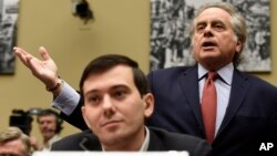 Benjamin Brafman, right, attorney for pharmaceutical chief Martin Shkreli, foreground, speaks on Capitol Hill in Washington, Feb. 4, 2016, during a House Committee on Oversight and Reform Committee hearing on rising drug prices. 