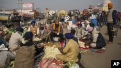 Protesting farmers prepare a meal for fellow farmers as they block a major highway during a protest at the Delhi-Haryana state border, India, Dec. 1, 2020.