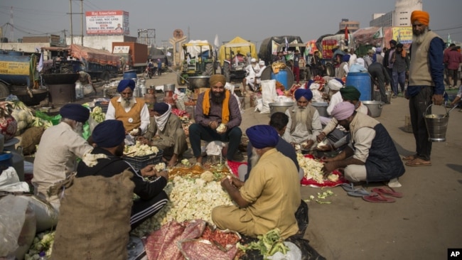 Protesting farmers prepare a meal for fellow farmers as they block a major highway during a protest at the Delhi-Haryana state border, India, Dec. 1, 2020.