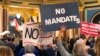 Numerosos manifestantes se congregan en el Capitolio de Iowa en Des Moines, el jueves 28 de octubre de 2021, para exigir a la legislatura que apruebe una medida tendente a prohibir la obligatoriedad de las vacunas entre los empleados locales.
