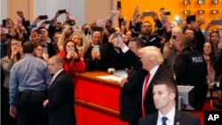 President-elect Donald Trump gives a thumbs-up to the crowd as he leaves the New York Times building following a meeting in New York, Nov. 22, 2016. 