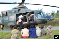 Soldiers and paramedics carry injured people from a helicopter in Chimanimani, about 600 kilometers southeast of Harare, Zimbabwe, March, 19, 2019.