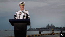 Commander of the U.S. Pacific Fleet Scott Swift answers questions during a press conference with the USS John S. McCain and USS America docked in the background at Singapore's Changi naval base in Singapore, Aug. 22, 2017.