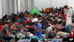 Central American migrants settle in a shelter at the Jesus Martinez stadium in Mexico City, Tuesday, Nov. 6, 2018. 