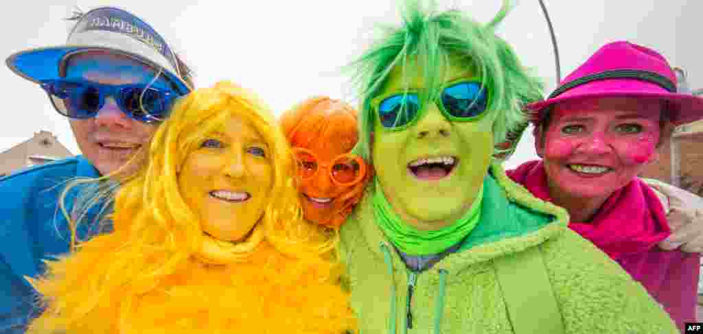 People celebrate in the streets of Damme near Osnabrueck, northern Germany, during a traditional carnival parade.