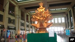 This Nov. 26, 2021 photo shows "The Giving Tree," a Christmas tree display made out of cardboard at Asbury Park NJ's Convention Hall. (AP Photo/Wayne Parry)