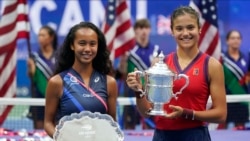 Leylah Fernandez and Emma Raducanu pose with their trophies after the U.S. Open final on Saturday.
