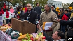 Rep. Luis Gutierrez, an Illinois Democrat, accompanied by United Farm Workers President Arturo Rodriguez, speaks at a Washington rally to urge President Barack Obama to move forward on executive action on immigration, Nov. 19, 2014.