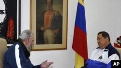 Cuba's former President Fidel Castro (L) visits Venezuela's President Hugo Chavez, who is recovering from surgery, in Havana, March 2, 2012. 