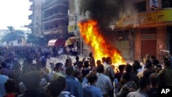 Protesters storm an office of Egyptian President Mohammed Morsi's Muslim Brotherhood Freedom and Justice party and set fires in the Mediterranean port city of Alexandria, Egypt, Nov. 23, 2012.