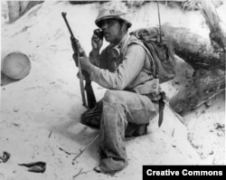 A Navajo Code Talker relays a message on a field radio. The code talkers served in the South Pacific during World War II and were kept a secret until 1968 when the code was finally declassified.