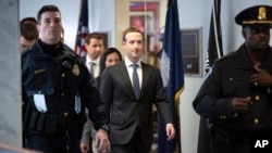 Facebook CEO Mark Zuckerberg leaves a meeting with Sen. Bill Nelson, D-Fla., the ranking member of the Senate Commerce Committee, on Capitol Hill in Washington, Monday, April 9, 2018. (AP Photo/J. Scott Applewhite)