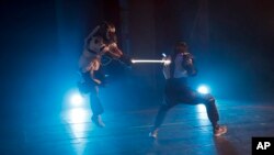 Competitors battle during a national lightsaber tournament in Beaumont-sur-Oise, north of Paris, In Feb. 10, 2019.