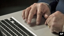 A cyber warfare expert works on his laptop computer in Charlotte, North Carolina, December 1, 2011.
