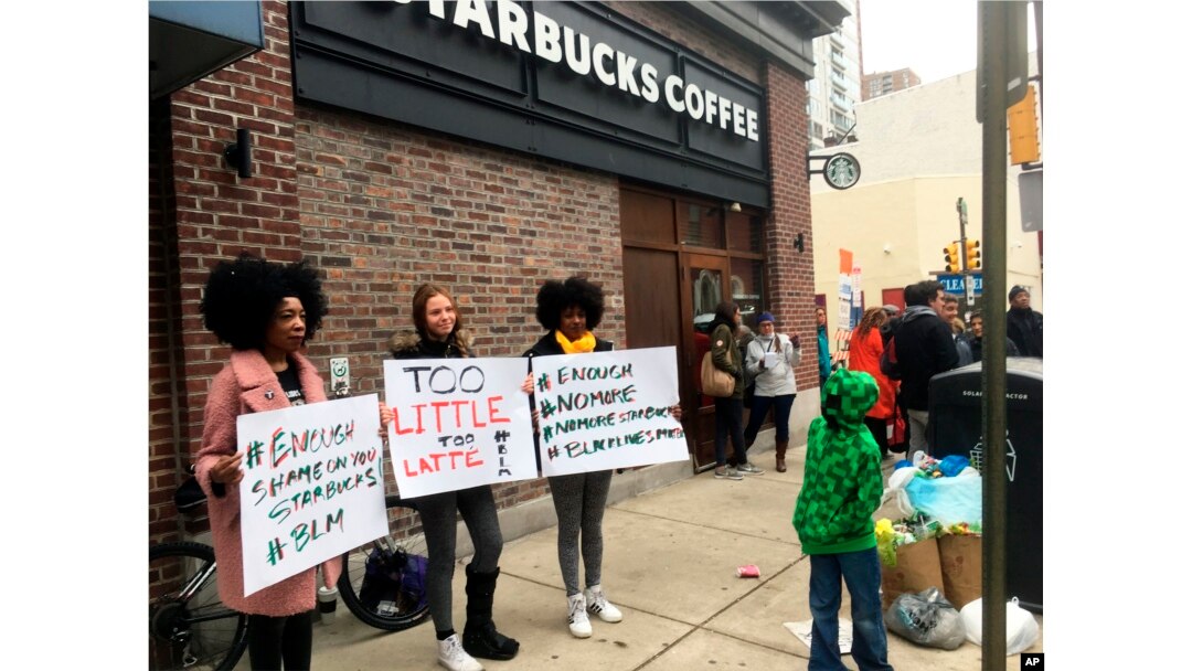 Protesters gather outside a Starbucks in Philadelphia, April 15, 2018, where two black men were arrested Thursday after Starbucks employees called police to say the men were trespassing.