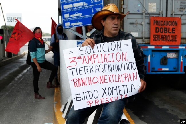 FILE - Atenco residents protest the construction of the new Mexico City airport near their community, near Texcoco, Mexico, Oct. 12, 2018.