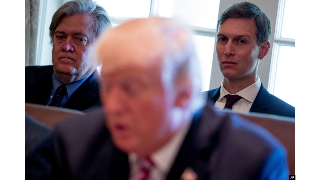 FILE - Then-White House Senior Advisers Steve Bannon, left, and Jared Kushner, listen as President Donald Trump speaks during a Cabinet meeting, June 12, 2017, in the Cabinet Room of the White House in Washington.
