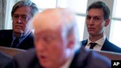 White House Senior Advisers Steve Bannon, left, and Jared Kushner, listen as President Donald Trump speaks during a Cabinet meeting, June 12, 2017, in the Cabinet Room of the White House in Washington.