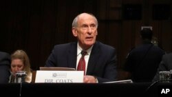 FILE - Director of National Intelligence Dan Coats prepares to testify before the Senate Intelligence Committee, on Capitol Hill in Washington, May 11, 2017. He is said to have been asked by President Donald Trump to disavow possible Russian collusion with his election campaign but refused to confirm such reports.