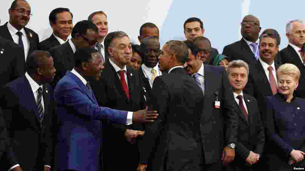 U.S President Barack Obama (C) arrives for a family photo during the opening day of the World Climate Change Conference 2015 (COP21) at Le Bourget, near Paris, France, November 30, 2015.