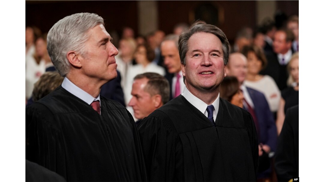 FILE - Supreme Court Associate Justices Neil Gorsuch, left, and Brett Kavanaugh watch as President Donald Trump arrives to give his State of the Union address to a joint session on Congress at the Capitol in Washington, Feb. 5, 2019.