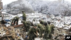 Japan Self Defense Force members search for victims of the March 11 earthquake and tsunami in Miyako City, Miyagi Prefecture, March 26, 2011