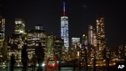 The One World Trade Center spire is lit blue, white and red after New York Gov. Andrew Cuomo announced the lighting in honor of dozens killed in the Paris attacks, Nov. 13, 2015. 