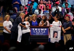 Republican presidential candidate Donald Trump kisses mothers from the Remembrance Project, who have lost sons to violence by illegal immigrants, as he speaks at a campaign rally in Austin, Texas, Aug. 23, 2016.