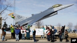 FILE - Protesters rally outside the Iowa Air National Guard base in Des Moines, Iowa, March 17, 2014. Seven people who were rallying against the use of drones to carry out military strikes were arrested. On May 13 of that year, diplomats in Geneva began discussing for the first time at the U.N. whether new international laws were needed to govern the use of lethal autonomous weapons systems that could go beyond human-directed drones, if emerging technologies made their development possible.