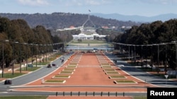 Australia's Parliament House (top) is visible above the old Parliament House (white building below) and Anzac Parade (foreground) in Canberra, (File photo).