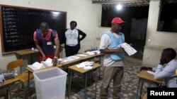 Election officials count ballot papers after the closing of the national election in the capital Luanda, Angola, August 31, 2012.