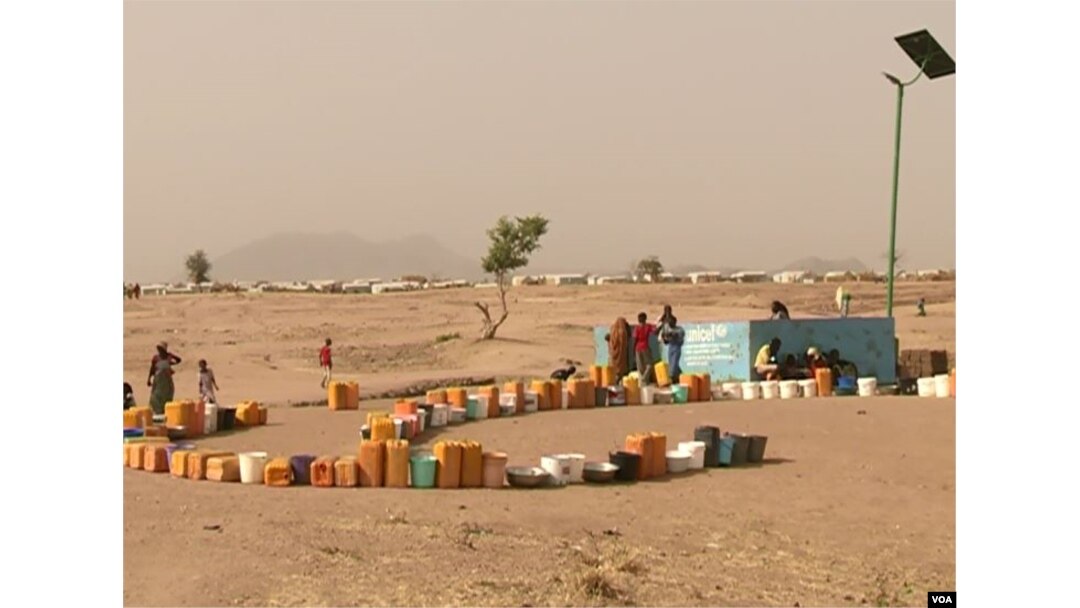 FILE - Refugees set out containers waiting for UNHCR to fill them with water, at Minawao refugee camp, northern Cameroon, Feb. 9 2018. (M. Kindzeka/VOA)