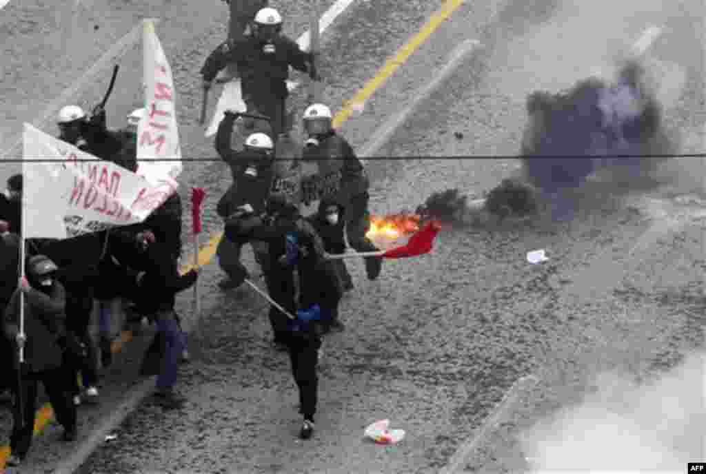 Riot police clash with protesters outside the Greek Parliament during a demonstration in central Athens, Wednesday, Dec. 15, 2010. Hundreds of protesters clashed with riot police across central Athens Wednesday, smashing cars and hurling gasoline bombs du