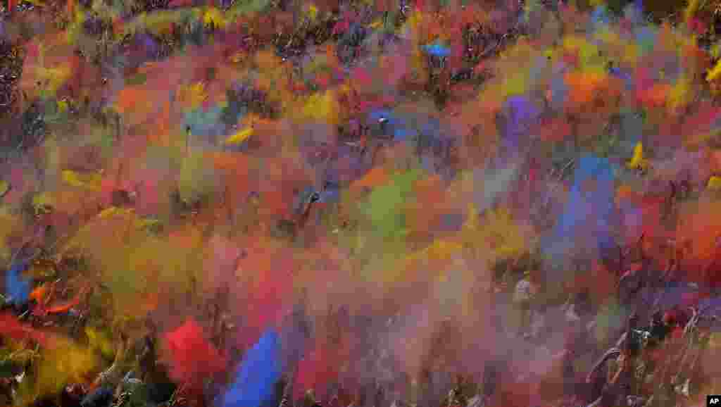 Visitors of the Holi Festival of Colors throw special colored powders in the air in Barcelona, Spain, April 6, 2014.