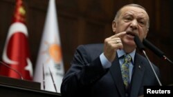 FILE - Turkish President Tayyip Erdogan addresses members of parliament from his ruling AK Party (AKP) during a meeting at the Turkish parliament in Ankara, Turkey, Jan. 15, 2019. 