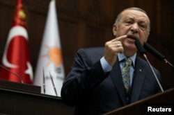 FILE - Turkish President Tayyip Erdogan addresses members of parliament from his ruling AK Party (AKP) during a meeting at the Turkish parliament in Ankara, Turkey, Jan. 15, 2019.