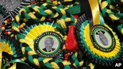 A picture of former South African President Nelson Mandela is seen on memorabilia sold in Bloemfontein. South Africa's ruling African National Congress (ANC) celebrates its 100th birthday on Sunday, January 6, 2012.