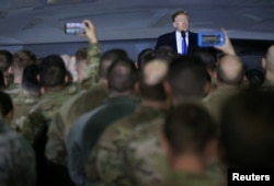 President Donald Trump speaks to members of the U.S. military after his summit meeting with North Korea's Kim Jong Un in Vietnam, during a refueling stop at Elmendorf Air Force Base in Anchorage, Alaska, Feb. 28, 2019.