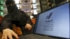 Saudi woman Fawzia al-Harbi, a candidate for local municipal council elections, shows her candidate biography at a shopping mall in Riyadh, Saudi Arabia, Nov. 29, 2015.