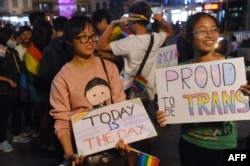 FILE - Members of the local lesbian, gay, bisexual and transgender and intersex community gather to celebrate a law newly approved by the National Assembly on transgenders in Hanoi, Nov. 24, 2015.