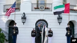 FILE - President Barack Obama, left, shakes hands with Sheikh Mohamed bin Zayed Al Nahyan, Crown Prince of Abu Dhabi, Deputy Supreme Commander of the UAE Armed Forces and Chairman of the Executive Council of the Emirate of Abu Dhabi, as he arrives at the 