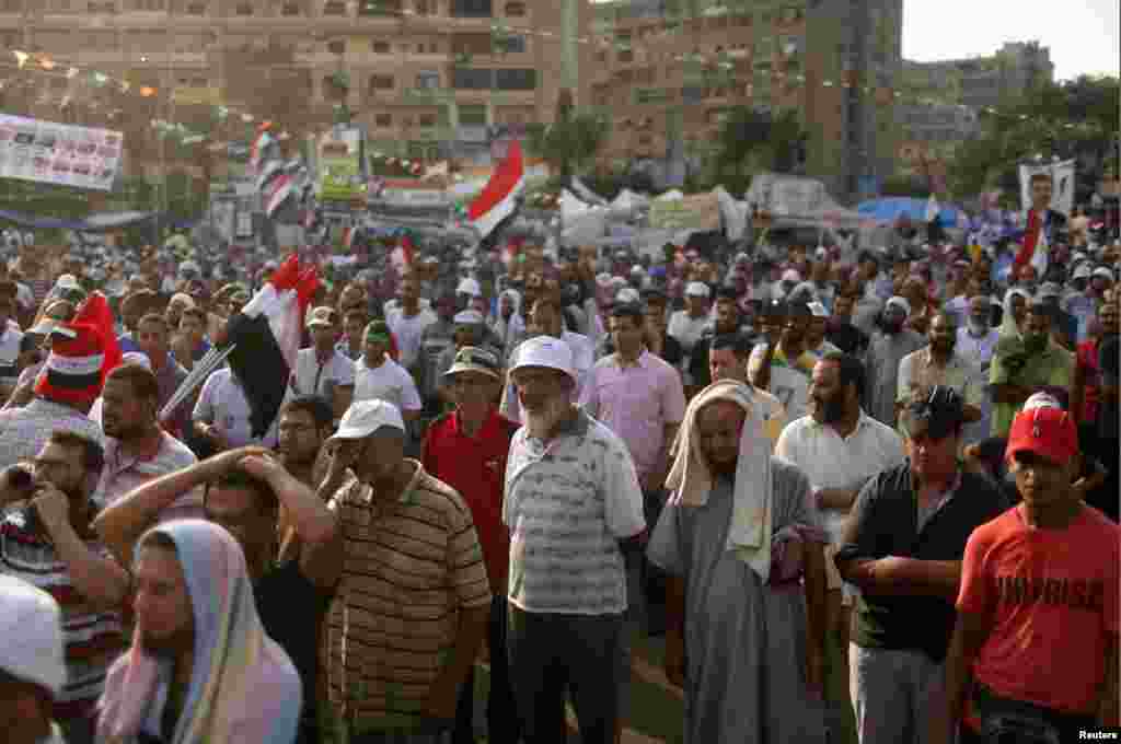 Supporters of deposed President Mohamed Morsi listen to a speech during a rally around the Raba El-Adwyia mosque square in Cairo, July 24, 2013. 
