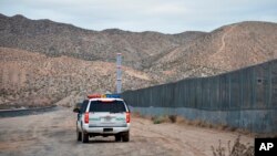 FILE - A U.S. Border Patrol agent patrols Sunland Park along the U.S.-Mexico border next to Ciudad Juarez, Jan. 4, 2016.