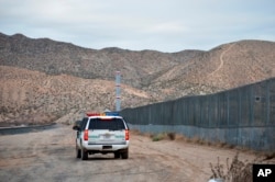 FILE - In this Jan. 4, 2016, file photo, a U.S. Border Patrol agent patrols Sunland Park along the U.S.-Mexico border next to Ciudad Juarez.