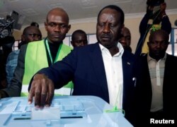 Kenyan opposition leader Raila Odinga, the presidential candidate of the National Super Alliance (NASA) coalition, casts his vote during the presidential election at Kibera primary school, outside the Kibera slums of Nairobi, Kenya, Aug. 8, 2017.