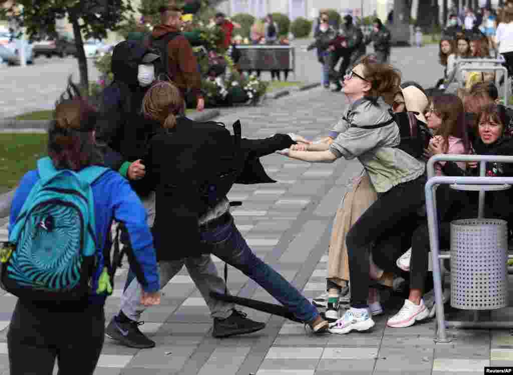 A plainclothes law enforcement officer detains a student during a protest against presidential election results in Minsk, Belarus.