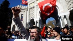 FILE - Demonstrators protest, Nov. 3, 2016, in Istanbul after a purge of thousands of education staff at Istanbul University the attempted coup in July. The fallout continued Jan. 6, 2017 when 6,000 more Turks were dismissed from their jobs.
