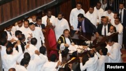 Sri Lanka's parliament members argue in front of the speaker Karu Jayasuriya during the parliament session in Colombo, Nov. 15, 2018. 