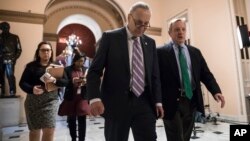Senate Minority Leader Chuck Schumer, D-N.Y. (L) walks with Sen. Dick Durbin, D-Ill., the minority whip, as lawmakers continue negotiating on a deal that would include a fix for the Deferred Action for Childhood Arrivals (DACA) program, at the Capitol in Washington, Jan. 11, 2018. 