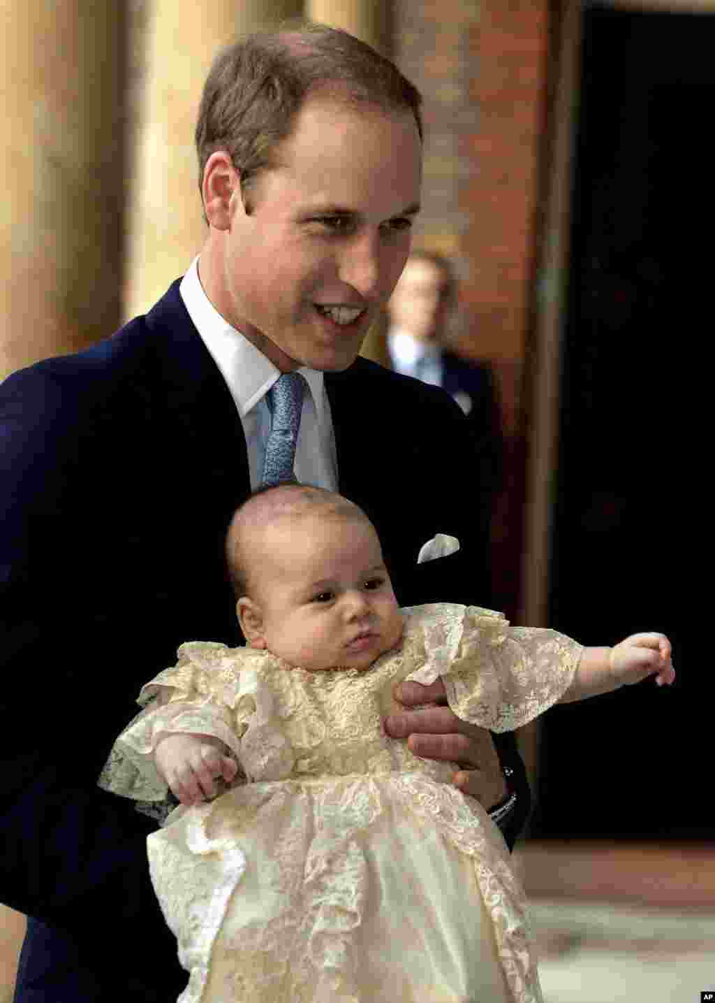 Britain's Prince William, holds his son Prince George as they arrive at Chapel Royal in St James's Palace in London, for the christening of the three month-old Prince, Oct. 23, 2013.